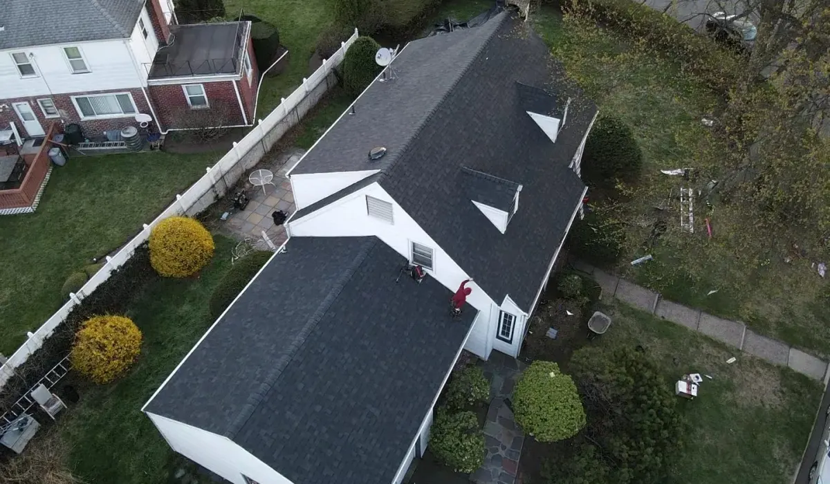A low-slope flat roof on a New Jersey home with EPDM membrane, drains, and parapet wall flashing