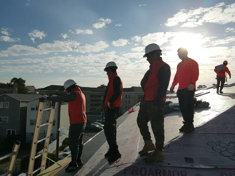 Our crew on a roof at golden hour